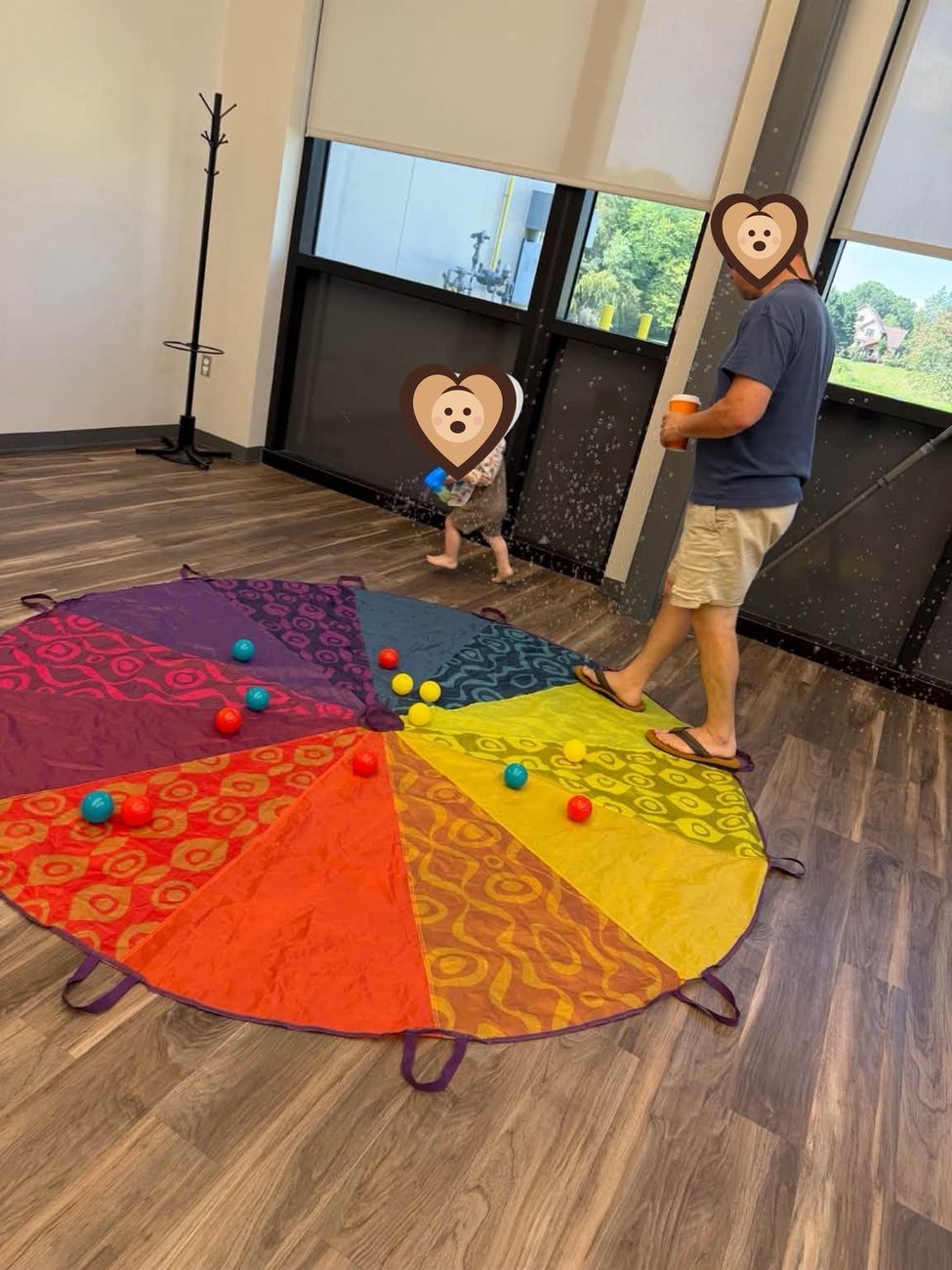Parachute play with balls during a Giggles and Growth class